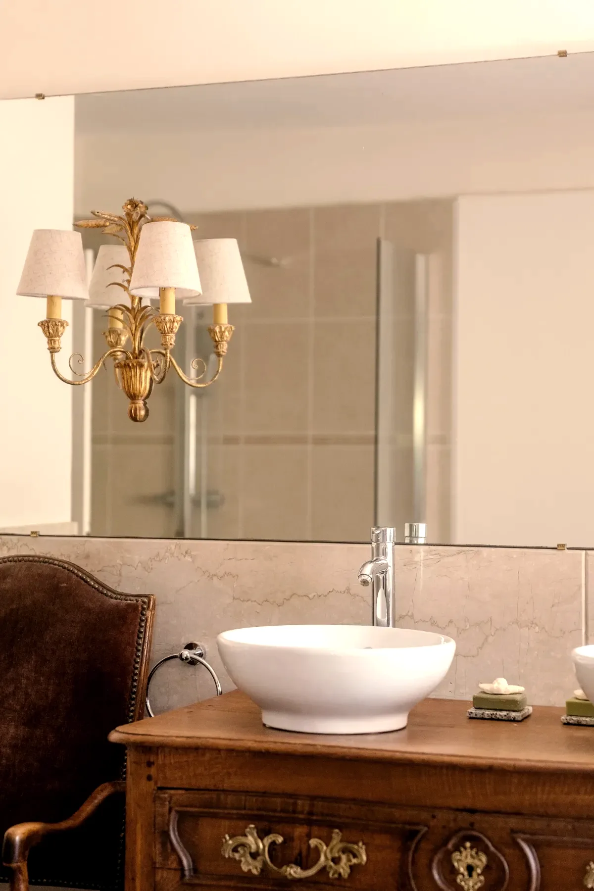 Salle de bain, vasque sur commode ancienne et applique dorée